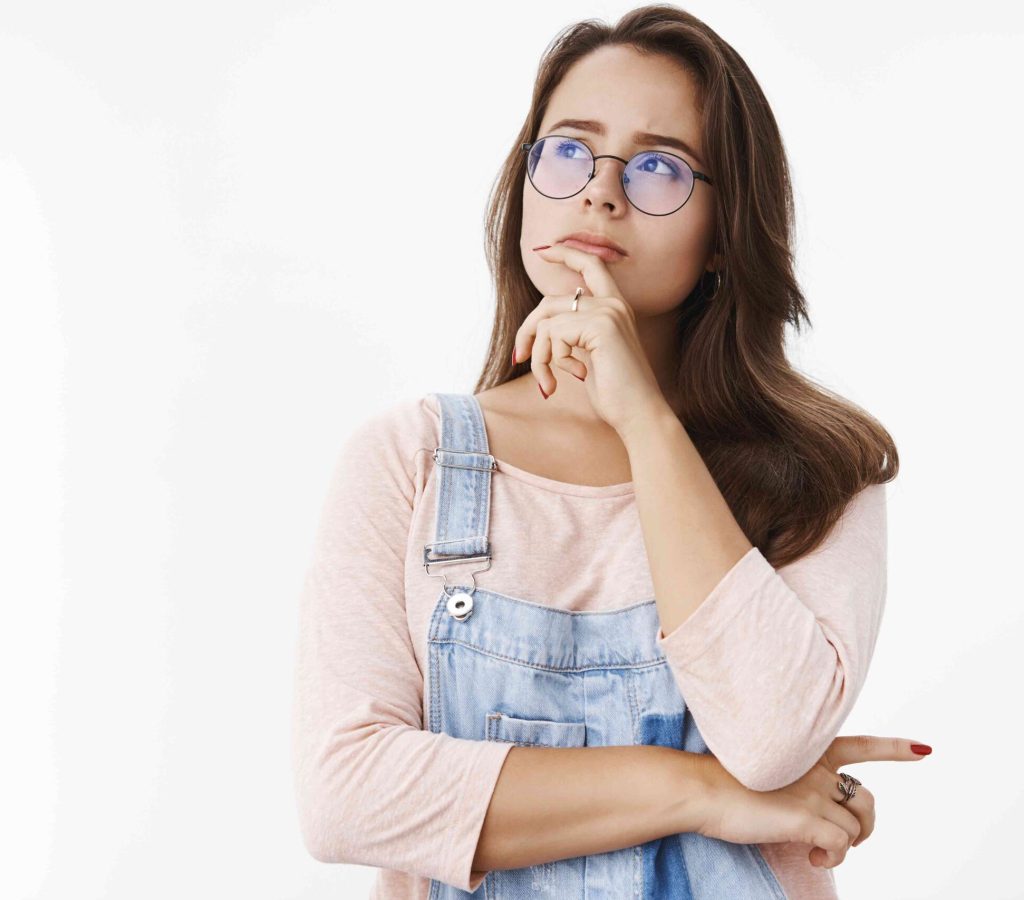 girl-makin-assumption-solving-mistery-mind-holding-finger-lip-looking-upper-left-corner-determined-thoughtful-as-thinking-making-decision-choice-standing-focused-gray-background